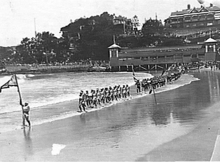 March past at a surf carnival at southern end of Manly Beach