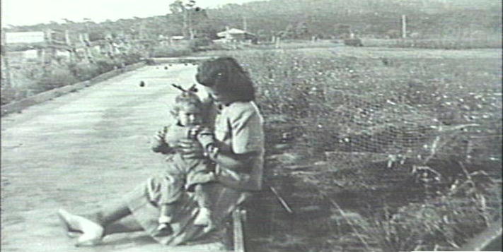 Mirta and Nita sitting on bowling alley, Dee Why