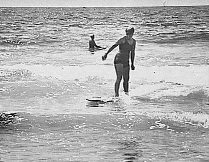 Woman riding a surfboard, Freshwater Beach