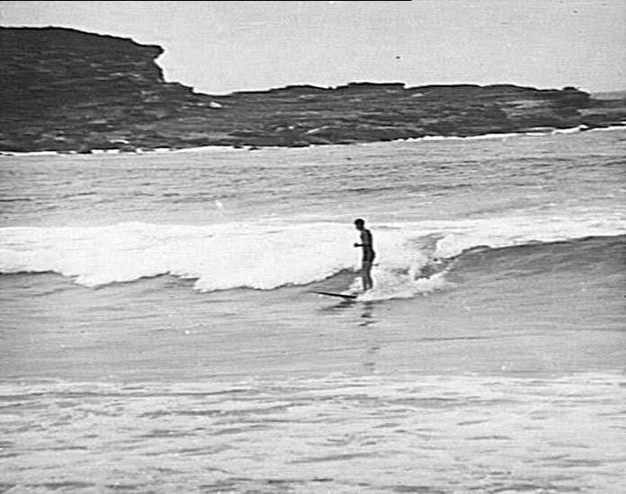 Man riding a surfboard, Freshwater Beach