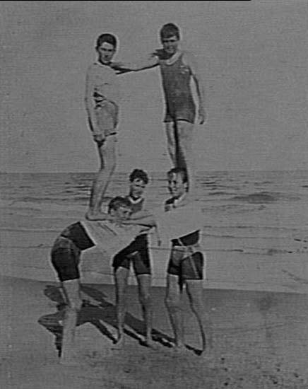 Unidentified boys forming human pyramid, Manly Beach