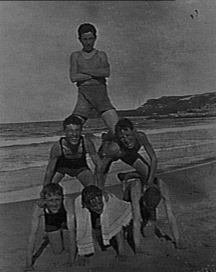 Unidentified boys forming human pyramid, Manly Beach