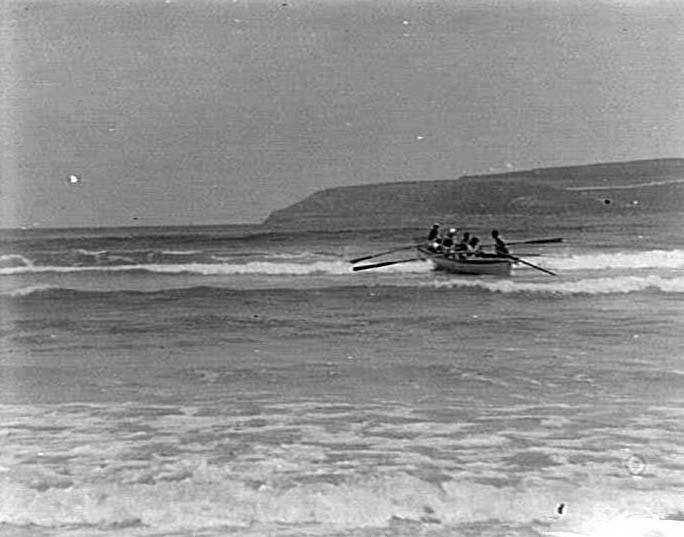 Rowboat going out through waves