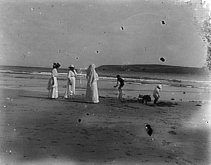 Ladies with children playing at a beach