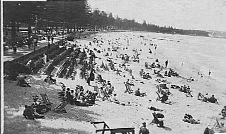 Rows of deck-chairs on the sand at Manly Beach, c 1921