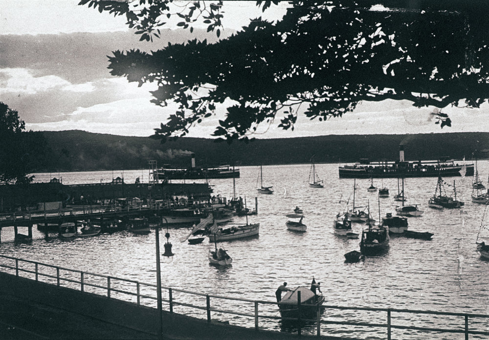 Boats on Manly Cove preparing for a Venetian Carnival