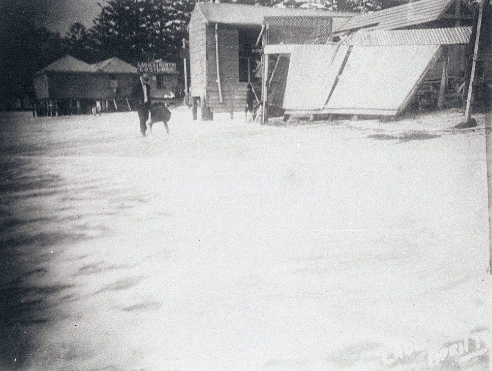 Manly Beach during high seas, showing the dressing sheds
