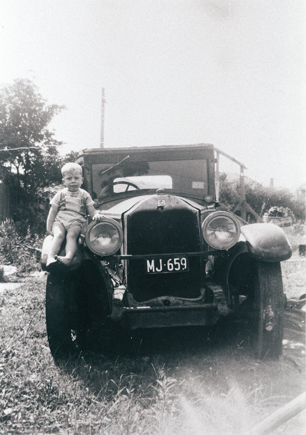 John Harwood sitting on the fender of a 1927 Buick, Seaforth