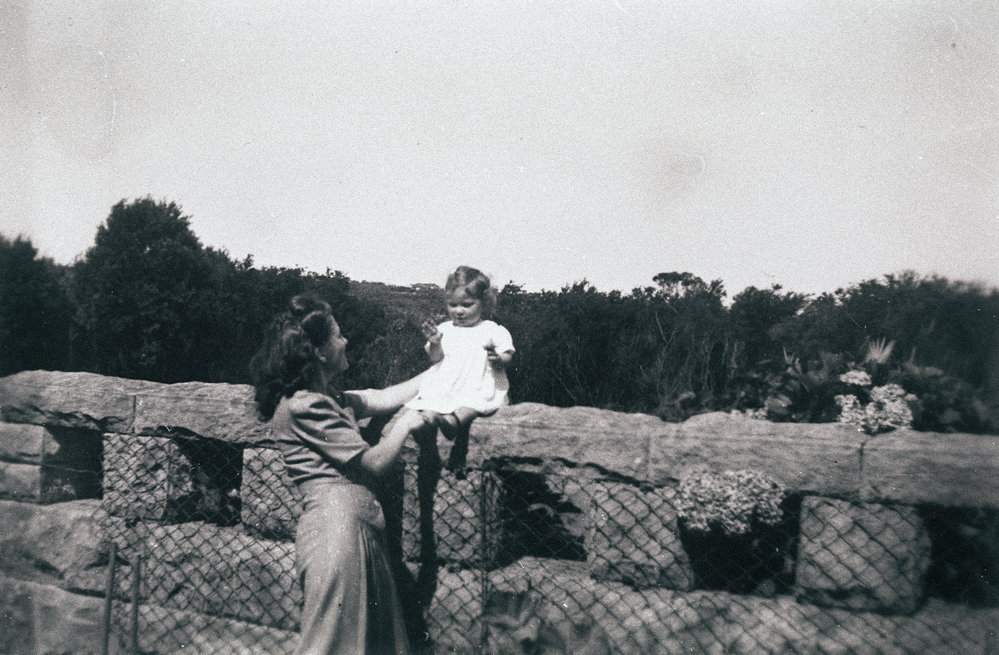 Wynn Harwood and daughter Lorraine sitting on stone fence, Seaforth