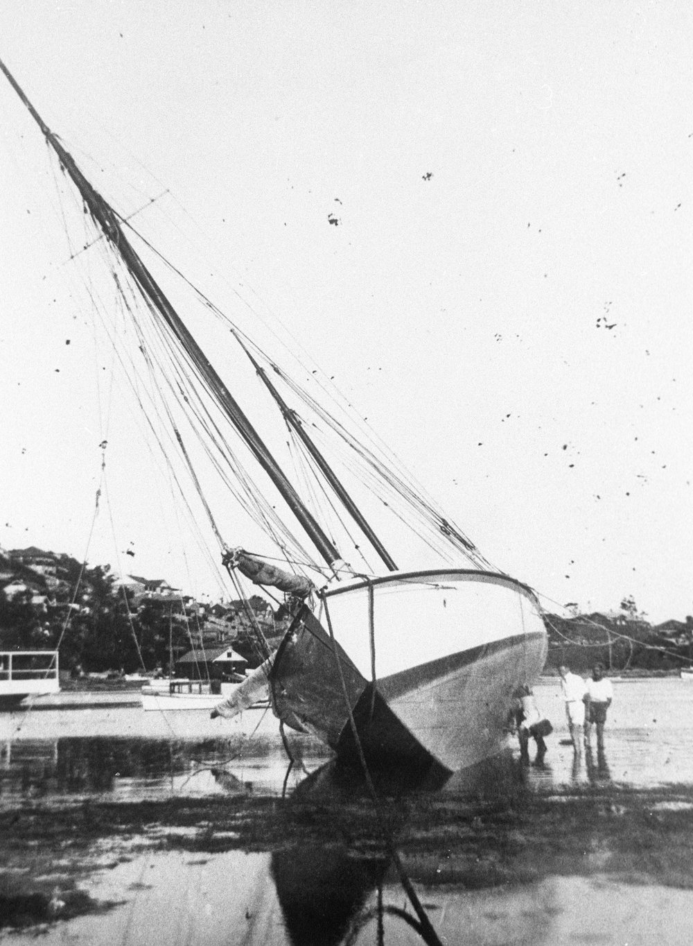 Ketch careened on sand flats at North Harbour, c 1930