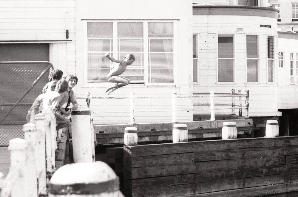 Boy diving off Manly Wharf