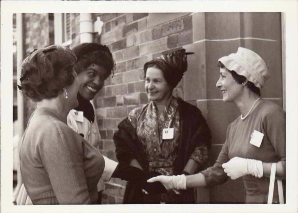 Winifred Atwell being greeted by three women, 1961