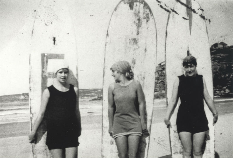 Isabel Letham and friends posing with surfboards at Freshwater Beach