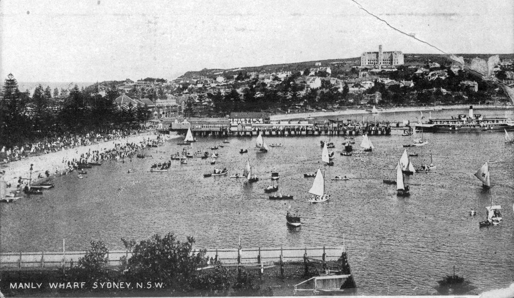 Sailing boats at Manly Cove near wharf