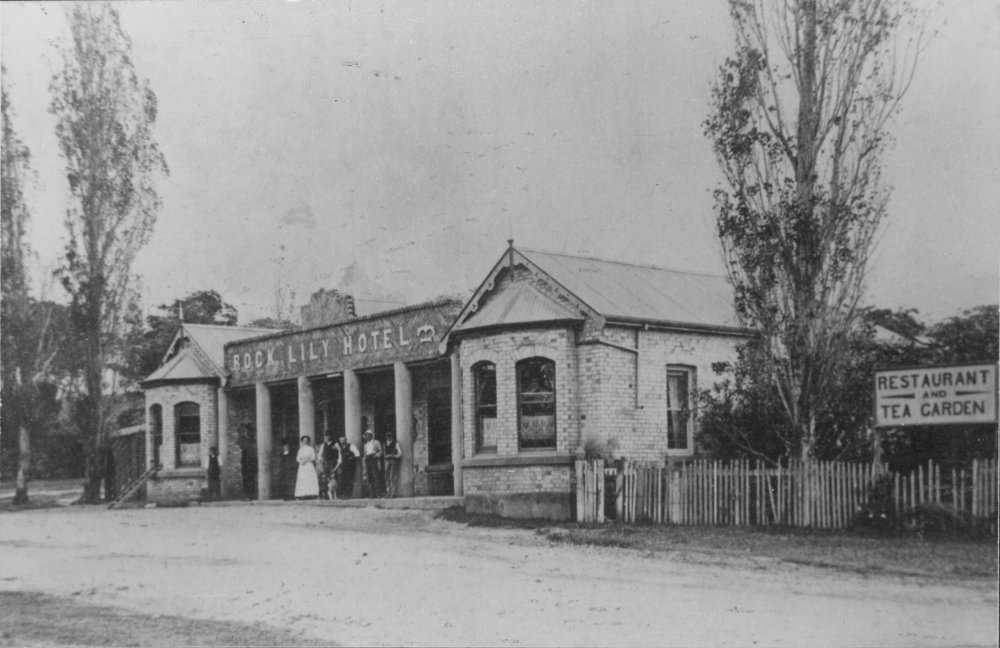 Owners and employees (presumably) standing on the verandah of the Rock Lily Hotel, 1907