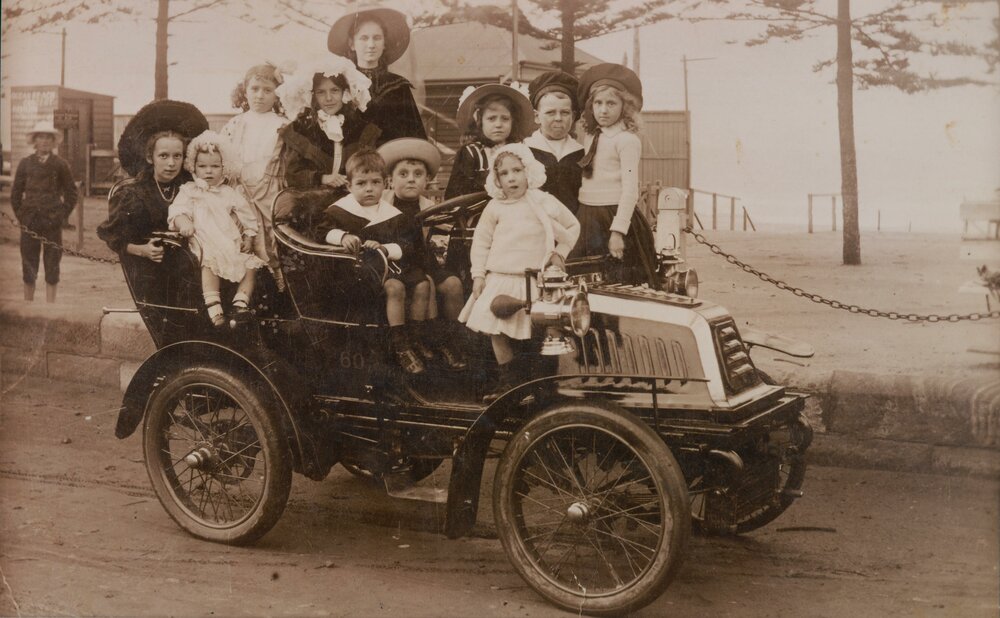 Group portrait of youths aboard a vintage motor vehicle, Manly Beach, 1908