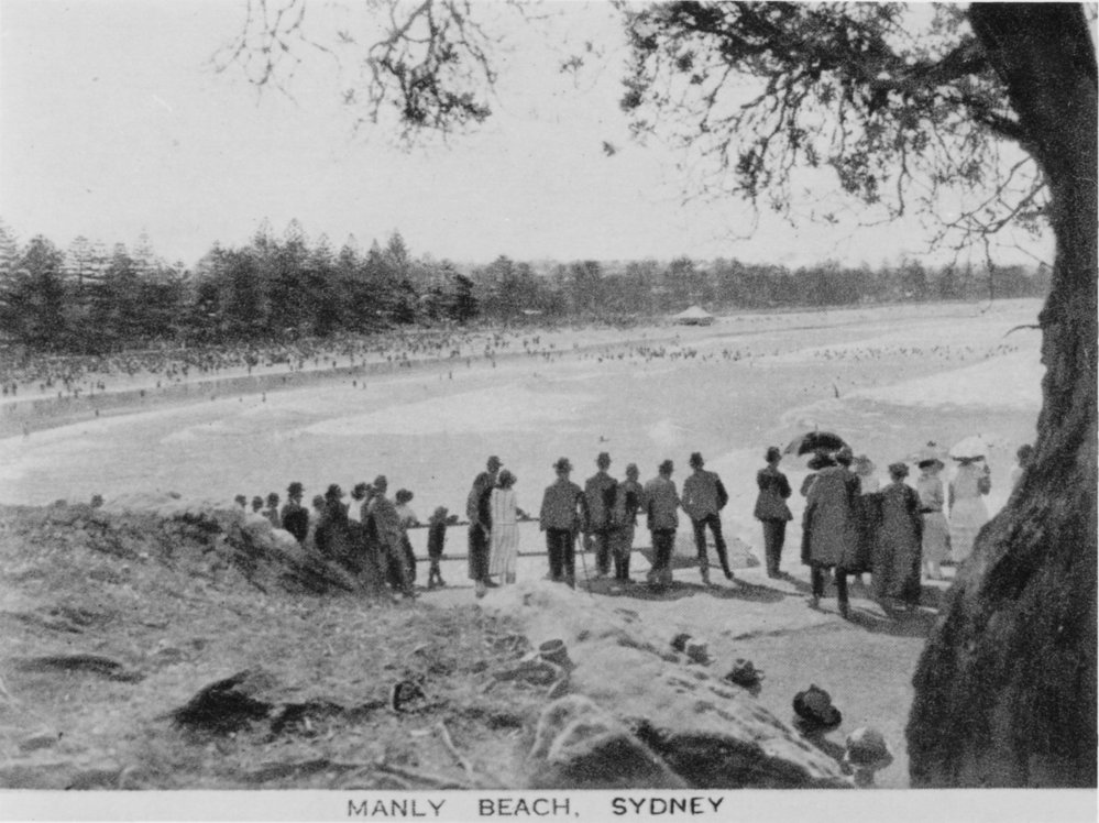 Crowds gathered overlooking Manly Beach, viewed from Fairy Bower Walkway, c1920s