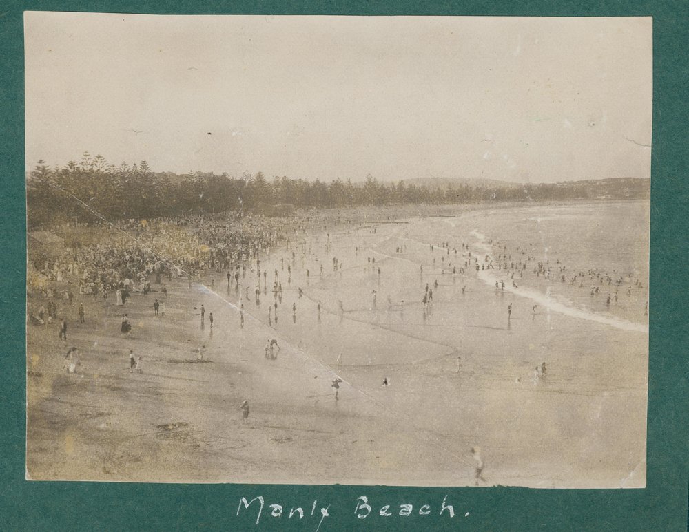 View facing north, showing large crowds gathered on Manly Beach, c1920s
