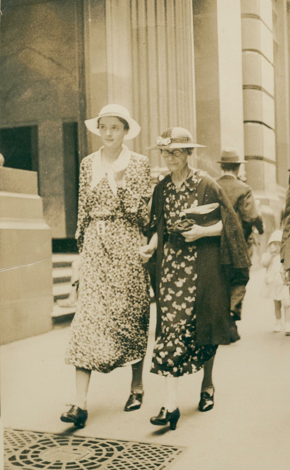 N P King and Principal Miss I Strachan of Manly Grammar School walking down a Sydney Street, c1920s