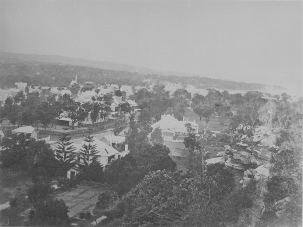 Elevated view over houses and trees, showing a rocky hillside, unidentified location, c1870