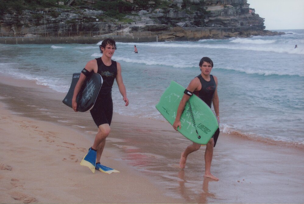 Two bodyboarders on Queenscliff Beach, with the pool and surf in background, 2005