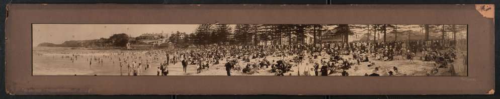 Panoramic view showing beach goers gathered at the southern end of Manly Beach, Manly, c1926
