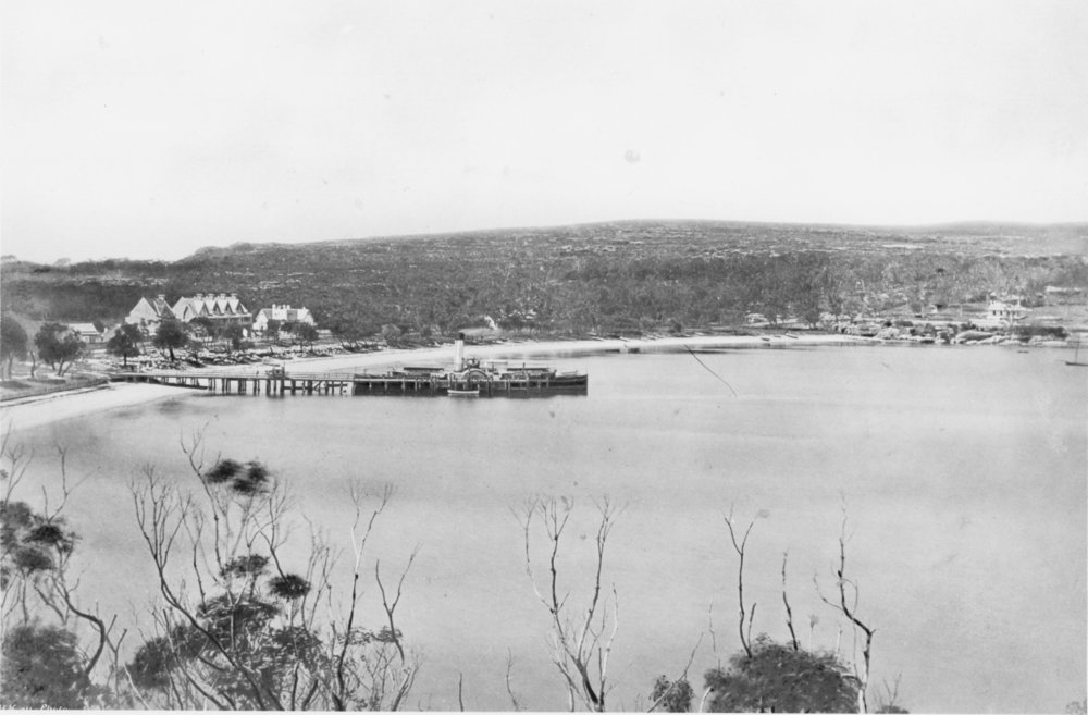 View facing east over Manly Cove showing Manly Wharf with a paddle steamer and nearby buildings, c1875 to c1879