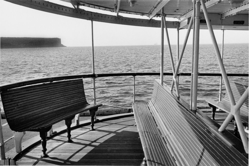 Outside deck of a Manly ferry, with North Head in the background, Manly, 1983