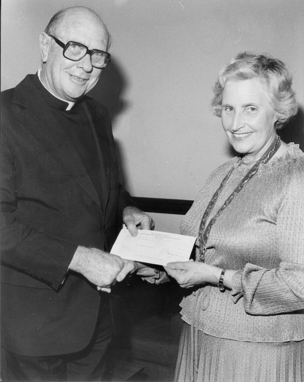 Portrait of Alderman Joan Thorburn presenting a cheque to Doctor Johnston from Colonial Day