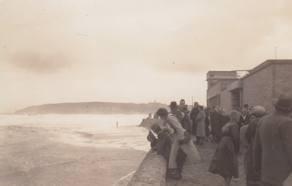 People watching rough seas at Queenscliff Beach, Queenscliff, 1950