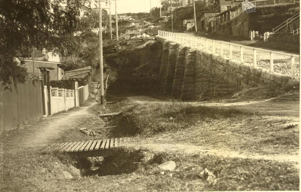 Clifford Avenue with temporary walkways over drainage trench, Fairlight, 1928