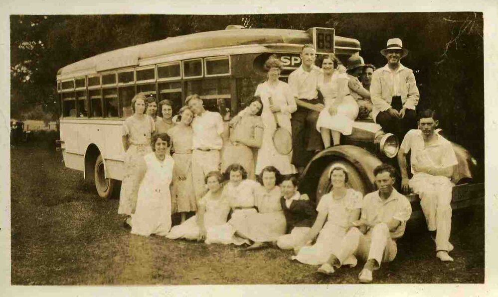 Bus picnic, Nancy Wooldridge and Walter Carpenter sitting at front wheel