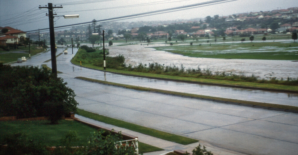 Pittwater Road, North Manly looking south showing Brookvale Creek in flood at Warringah Golf Course, 1961