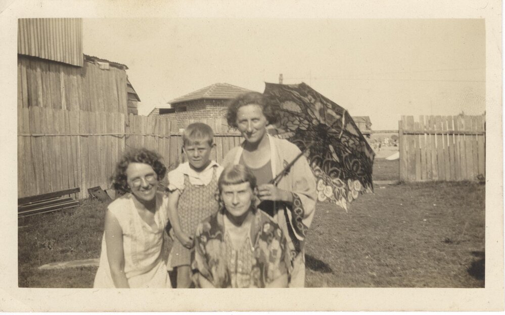 May Fowler and relatives in backyard of her dress maker shop on Pittwater Road Collaroy
