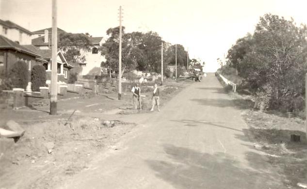 Woodland Street with houses and  people on unfinished nature strip, Balgowlah Heights, c1940s