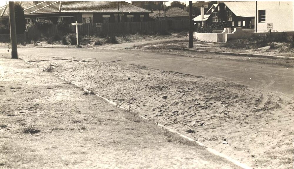 Unidentified street intersection and road drainage, c1940s