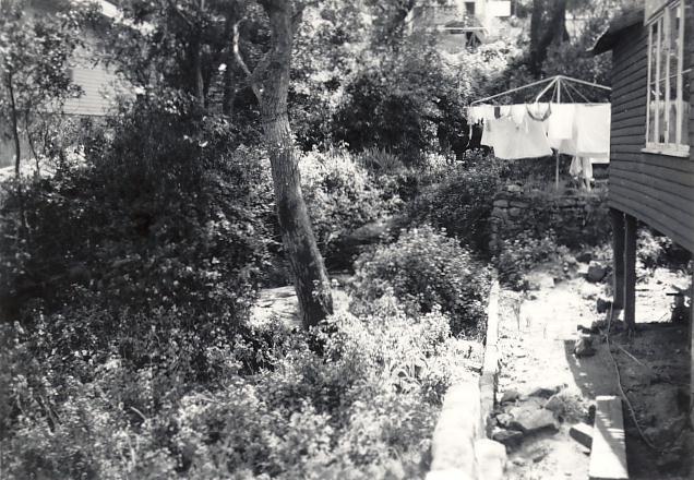 House with garden beds and clothesline, c1940s
