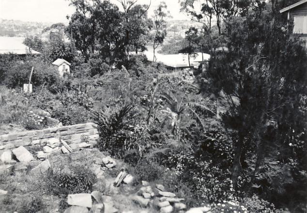 Garden beds on a property overlooking a waterway, c1940s