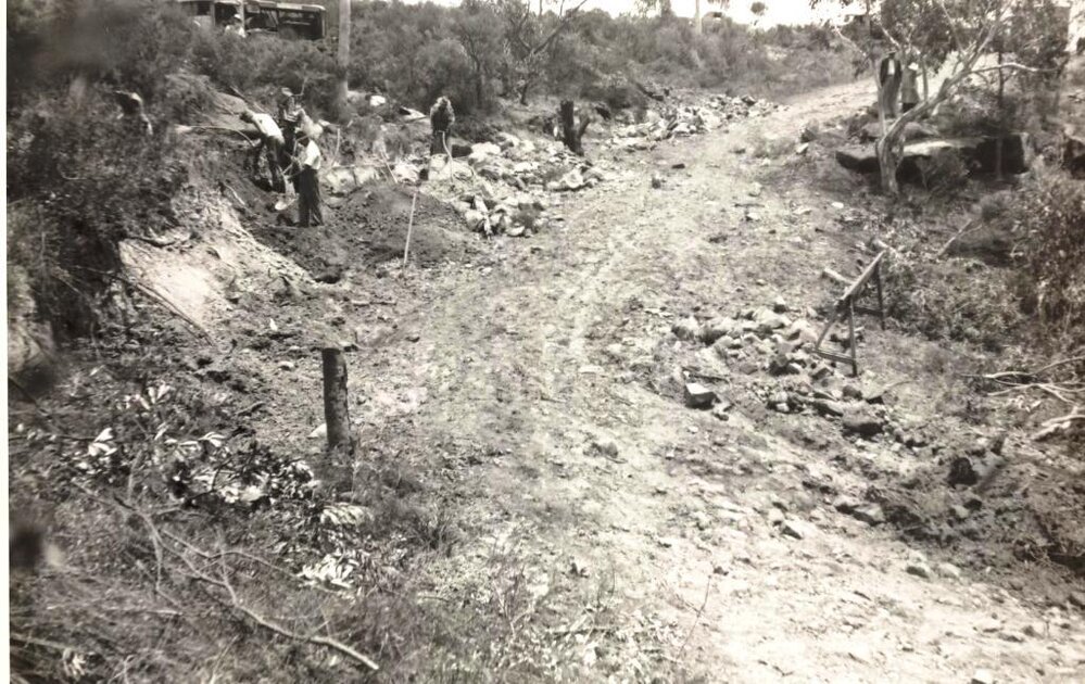 Labourers continue with roadworks, unidentified site, c1940s