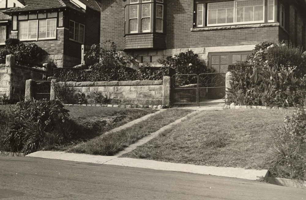 Historic houses showing front gardens and driveway with nature strip, c1940s