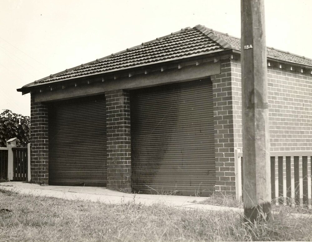 Brick double garage with tile pitched roof, post shows 18A, c1940s