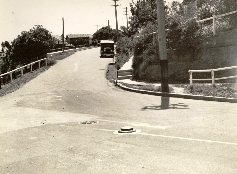 Unidentified street intersection with metal or concrete traffic dome, c1940s