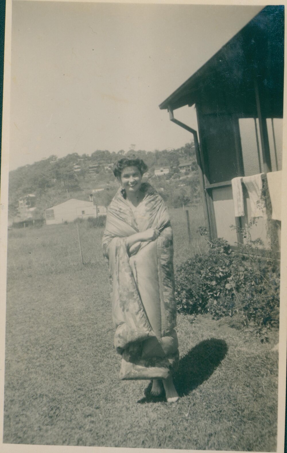 A woman draped in a blanket, Narrabeen, 1943