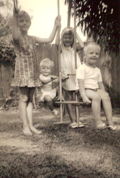Four of the Baird children on swings in yard at 18 St Andrews Gate, Elanora Heights, 1965