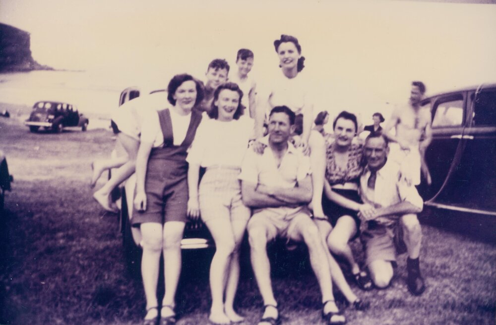 Group of young people sitting on car at Bilgola Beach, 1948