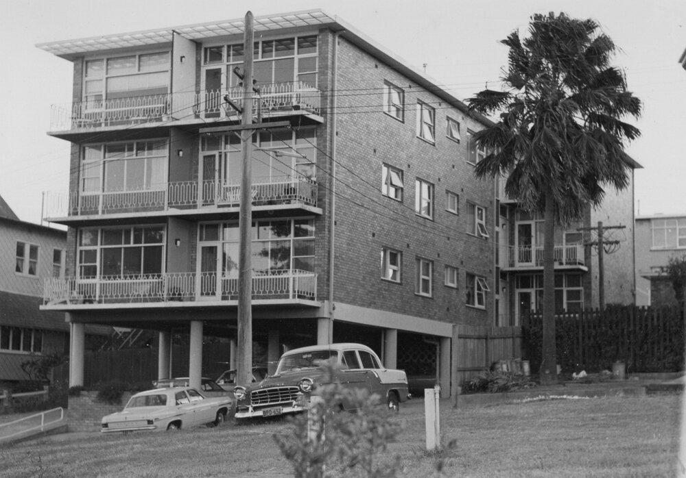 Brick apartment building with balconies and under-building parking, Manly, c1967-1973