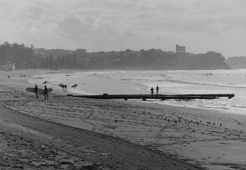 Stormwater drain and surfers at Manly Beach, Manly, c1967&ndash;1973