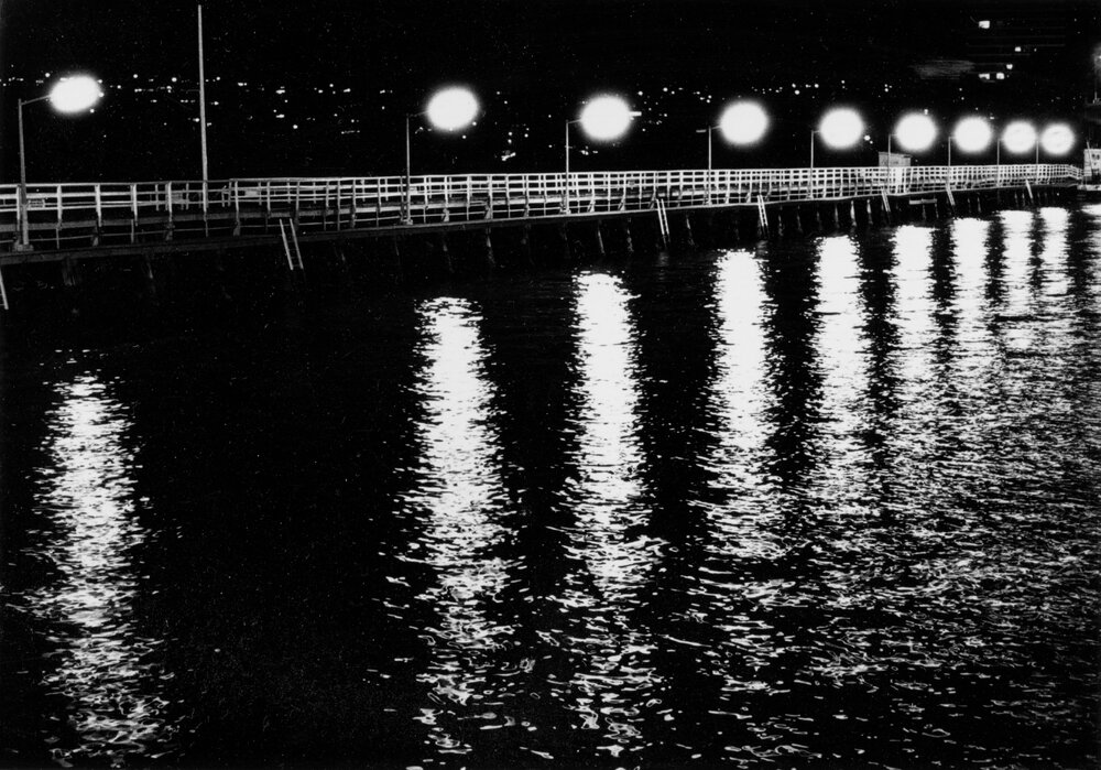 The old Manly boardwalk illuminated at night, Manly, c1967-1973