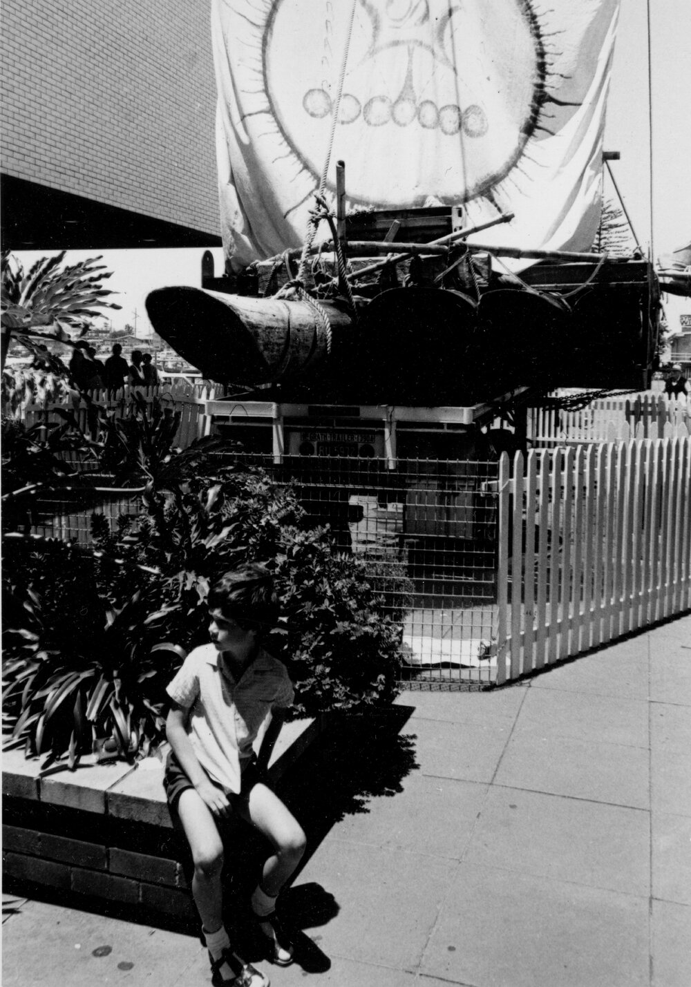 Boy seated near a sailing vessel display at Warringah Mall, Brookvale, c1967&ndash;1973