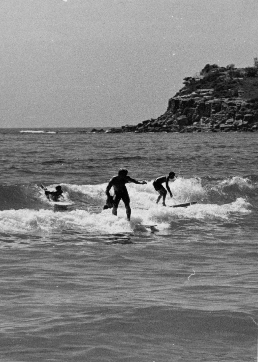 Surfers near the rocks at Manly Beach, Manly, 1972